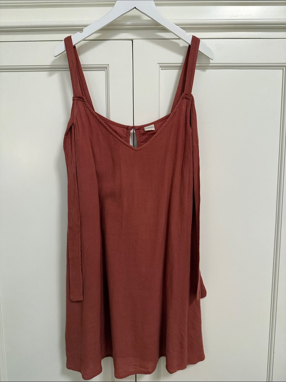 L*Space rust color mini dress, lined, side pockets. Side ties at shoulders